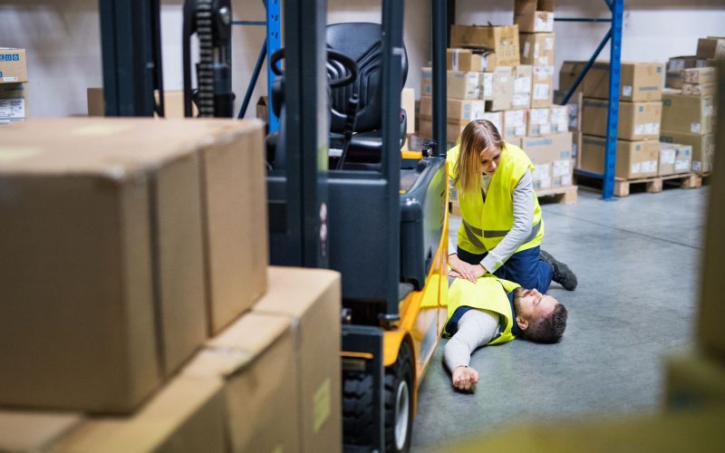 An accident in a warehouse. Woman performing cardiopulmonary resuscitation.